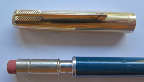 6313: PARKER 51 AEROMETRIC IMPACT PENCILS IN TEAL. GOLD FILL TRIM & CAP (WITH VERTICAL 5 LINE PATTERN SEPERATED BY WIDE BLANK BREAK IN PATTERN). MARBLED SILVER/GRAY JEWELE ON TOP. (HAVE 2 IN STOCK)