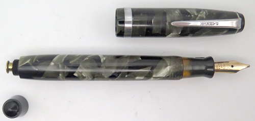 ITEM #3055: PARKER CHALLENGER FOUNTAIN PEN IN BLACK/GREY MARBLE. NIB IS 14K "PAKRER PEN" IN BROAD. FAIRLY CLEAR INK VIEW PORT IN THE SECTION.