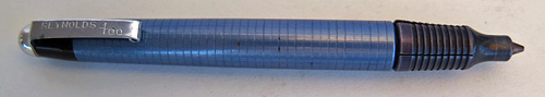 #4576: #4580: REYNOLDS 400 BALLPOINT IN ANODIZED BLUE BARREL WITH SQUARE PATTERN INSCRIBED AND BLACK TOP. FILLER TIP IS COVERED BY A SLIDING BALL PROTECTOR THAT CLICKS, WHICH IS AN INTEGERAL PART OF THE PEN. ELABORATE DISPLAY CASE CONTAINS A MACHINED ALUMINUM BASE. CONATINS PAPER DIRECTIONS AND GUARANTEE. THE CYLINDER BOX IS LIGHT BLUE/GOLD WITH REYNOLDS PEN LOGO VISIBLE