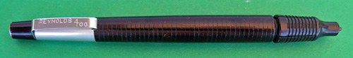 #4579: REYNOLDS 400 BALLPOINT IN BLACK WITH ALUMINUM TOP. FILLER TIP IS COVERED BY A SLIDING BALL PROTECTOR THAT CLICKS, WHICH IS AN INTEGERAL PART OF THE PEN. ELABORATE DISPLAY CASE CONTAINS A CLEAN CELLOPHANE COVER AND A MACHINED ALUMINUM BASE. CONATINS PAPER DIRECTIONS AND GUARANTEE. THIS UNIQUE SQUARE BOX COMES IN LIGHT BLUE VELVETEEN WITH A GOLD LID THAT HAS A PRINTED REYNOLDS "PEN" LOGO.