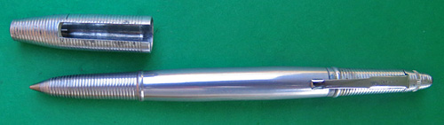 4588: REYNOLDS INTERNATIONAL BALLPOINT IN POLISHED ALUMINUM, WITH RED JEWELS ON BOTH SIDES. IN NEAR MINT CONDIDITION