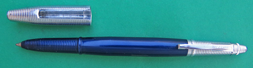 4589: REYNOLDS INTERNATIONAL BALLPOINT IN A LIGHTER ANODIZED DEEP BLUE, WITH BLACK DOT ON THE CAP, IN NEAR MINT CONDIDITION, NEVER USED. OF COURSE, THIS PEN DOES NOT WRITE BECAUSE THE FILLING SYSTEM IS DRIED OUT, THOUGH IT DID NOT WRITE WELL EVEN WHEN IT WAS NEW. THE INTERNATIONAL MODEL HAS A CAP/POINT COVER WHICH FITS OVER THE CAP OR THE POINT. THERE IS NO WEAR ON THE ANODIZING
