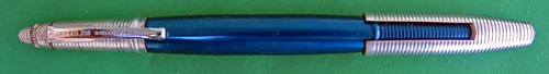 4591: REYNOLDS INTERNATIONAL BALLPOINT IN ANODIZED BLUE, IN NEAR MINT CONDIDITION, NEVER USED. OF COURSE, THIS PEN DOES NOT WRITE BECAUSE THE FILLING SYSTEM IS DRIED OUT, THOUGH IT DID NOT WRITE WELL EVEN WHEN IT WAS NEW. THE INTERNATIONAL MODEL HAS A CAP/POINT COVER WHICH FITS OVER THE CAP OR THE POINT. THERE IS NO WEAR ON THE ANODIZING