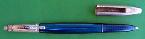4591: REYNOLDS INTERNATIONAL BALLPOINT IN ANODIZED BLUE, IN NEAR MINT CONDIDITION, NEVER USED. OF COURSE, THIS PEN DOES NOT WRITE BECAUSE THE FILLING SYSTEM IS DRIED OUT, THOUGH IT DID NOT WRITE WELL EVEN WHEN IT WAS NEW. THE INTERNATIONAL MODEL HAS A CAP/POINT COVER WHICH FITS OVER THE CAP OR THE POINT. THERE IS NO WEAR ON THE ANODIZING