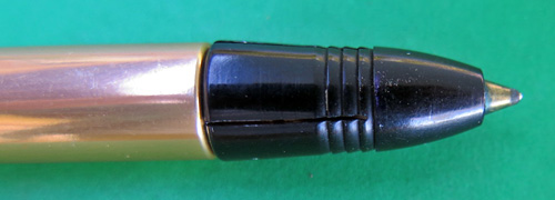 4596: REYNOLDS 400 BALLPOINT. SMOOTH GOLD ANODIZED ALUMINUM BARREL AND A BLACK CAP. THE FILLER TIP IS COVERED BY A SLIDING BALL PROTECTOR THAT CLICKS WHEN PULLED/PRESSED, WHICH IS AN INTEGERAL PART OF THE PEN. THIS PEN DOES NOT WORK AS THE FILLING UNIT IS DRIED OUT, BUT THE PEN DID NOT WORK WELL WHEN IT WAS NEW, EITHER.