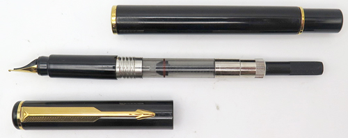 ITEM #4785: PARKER PLACE VENDOME or RIALTO 88 FOUNTAIN PEN IN GLOSSY BLACK LACQUER. GOLD CIRCLES ON BOTH TASSIE. GOLD PLATED TRIM. BROAD GOLD NIB. Comes with Parker piston converter filling system.