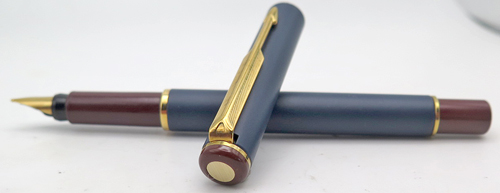 ITEM #4786: PARKER ARROW FOUNTAIN PEN IN MATTE BLUE LACQUER WITH MAROON TASSIES + SECTION. GOLD CIRCLES ON BOTH TASSIES. GOLD PLATED TRIM. GOLD NIB IS BROAD.