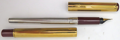 ITEM #4787: PARKER ARROW GOLD PLATED FOUNTAIN PEN. HAS MAROON BLIND CAPS + SECTIONS. GOLD TASSIES. GOLD NIB IN MEDIUM.