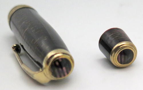 ITEM #6779: "George S. Parker VACUUM FILLER" (earlier than a vacumatic) IN LAMINATED BURGUNDY. LOCKDOWN FILLING SYSTEM WITH NO COROSION ON THE PLUNGER TUBE. STANDARD SIZE PEN WITH DOUBLE JEWEL. GOLD FILL TRIM. PARKER ARROW VAC NIB IN GOLD COLOR. NIB GRADE IS FINE. Made in USA.