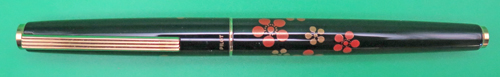 ITEM #6781: PILOT MAKIE FOUNTAIN PEN IN BLACK LACQUER WITH ORANGE & GOLD FLOWERS. IMPRINT IS "PILOT JAPAN". 14K NIBIN BROAD/MEDIUM (ON PARKER FACTORY NIB GRADER). DATE CODE ON NIB IS A597. SQUEEZE TYPE FILLING SYSTEM. 