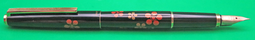 ITEM #6781: PILOT MAKIE FOUNTAIN PEN IN BLACK LACQUER WITH ORANGE & GOLD FLOWERS. IMPRINT IS "PILOT JAPAN". 14K NIBIN BROAD/MEDIUM (ON PARKER FACTORY NIB GRADER). DATE CODE ON NIB IS A597. SQUEEZE TYPE FILLING SYSTEM. 