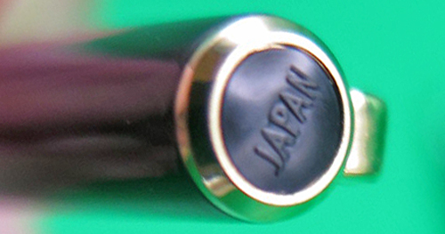 ITEM #6836: SAILOR ULTRA SLIM CHALANA FOUNTAIN PEN IN BROWN LACQUER STRIPE WITH NAVY SECTION. BLACK DOUBLE JEWEL. CAP JEWEL READS "JAPAN". 14K "SAILOR" NIB IN FINE. GOLD PLATED TRIM. NEW OLD STOCK IN BOX. Part #11-0520