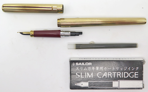 ITEM #6839: SAILOR CHALANA FOUNTAIN PEN + BALLPOINT SET IN GOLD STRIPE. BURGUNDY SECTION, JEWELS + CLIP STRIPE. FINE GOLD NIB WITH IMPRINT "SAILOR TIGP MADE IN JAPAN".