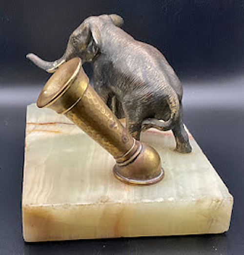 ITEM #6851: PARKER LIGHT COLORED ONYX MARBLE DESK BASE WITH BRASS ELEPHANT. BRASS PEN HOLDER. DIMENSION OF DESK BASE IS 5.5"x 3.5" x 4.33 INCHES. Trunk has been broken and glued on.