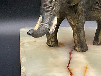 ITEM #6851: PARKER LIGHT COLORED ONYX MARBLE DESK BASE WITH BRASS ELEPHANT. BRASS PEN HOLDER. DIMENSION OF DESK BASE IS 5.5"x 3.5" x 4.33 INCHES. Trunk has been broken and glued on.